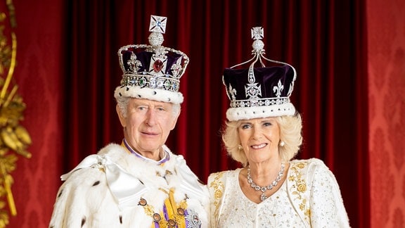 König Charles III and Königin Camilla posieren im Thronsaal.