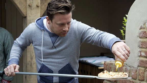 Chef Jamie Oliver baking bread. 