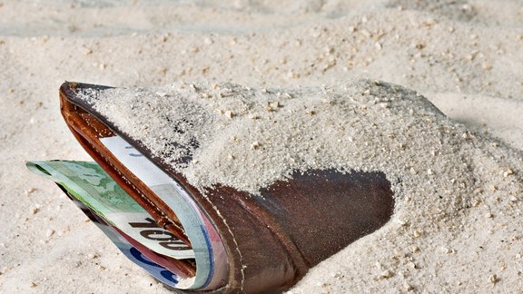 Portemonnaie liegt im Sand