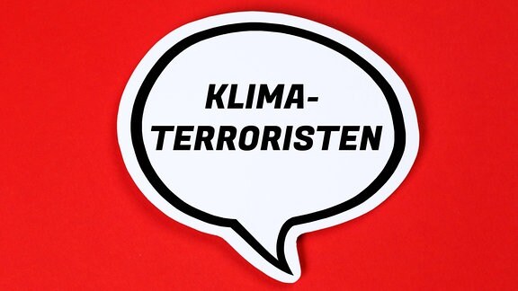 Wort "Klimaterroristen" in einer Sprechblase vor rotem Hintergrund