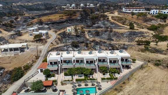 Luftbilder aus der Ortschaft Gennadi zeigen die Spuren des Feuers. Sie zeigen aber auch das Ergebnis der Brandbekämpfung durch Feuerwehr und Freiwillige, die Häuser haben kaum Schaden erlitten.